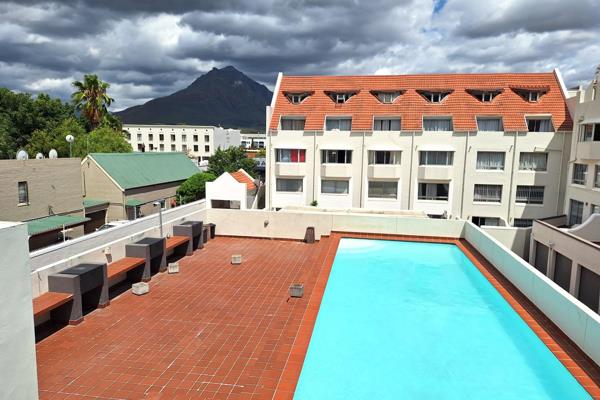 Set in a charming, historic building in the heart of Stellenbosch, this spacious apartment block offers a unique blend of old-world character and modern comforts. With four generously sized bedrooms, each featuring a stunning ...