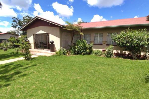 This lovely family home offers a warm and inviting living space. The living areas feature a dining room with a ceiling fan and a family ...