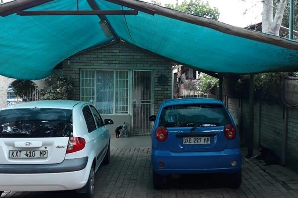 Single bedroom, bathroom and open plan living and kitchen area with a single carport ...