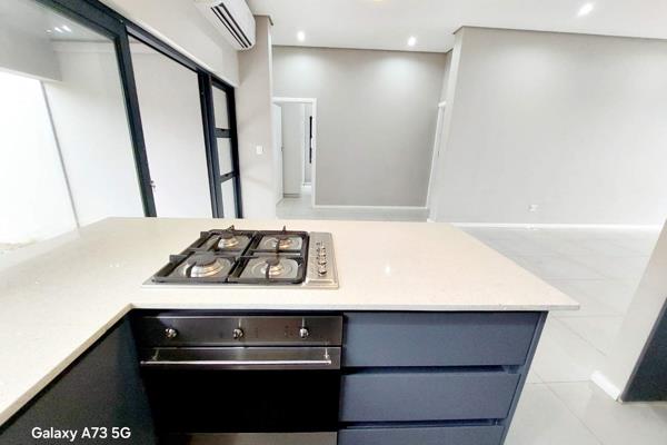 Experience contemporary living in this stunning unit, featuring double-volume ceilings and an open-plan design. The modern kitchen is ...