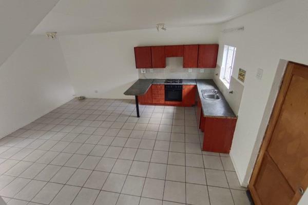 Entrance Hall
Tiled Lounge/dining area
Good sized kitchen with breakfast nook;  Place for appliances
Undercover patio leading to ...