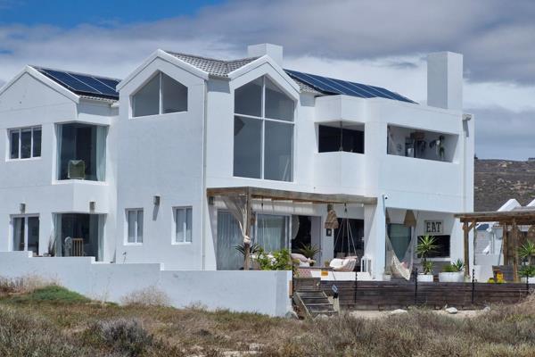 This is an exquisite, luxurious home at its finest.

With prime beachfront location ...