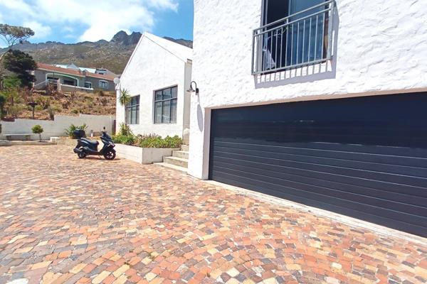 This stunning 4-bedroom, 4-bathroom home in Gordons Bay offers a perfect blend of modern industrial design and a cozy, loft-like ...