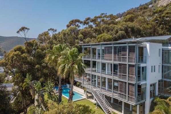 Uniquely situated on the green belt in the wind-protected suburb of Bantry Bay, this spectacular home flows seamlessly into its verdant ...