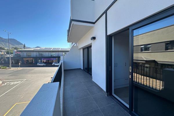 Enter this contemporary, spacious open plan living and kitchen area, with a sliding door leading onto a large, sunny balcony with ...