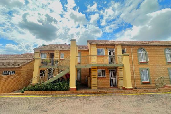 Neat 2-bedroom, 1 bathroom townhouse in Mooikloof Ridge Estate. Open plan living area ...