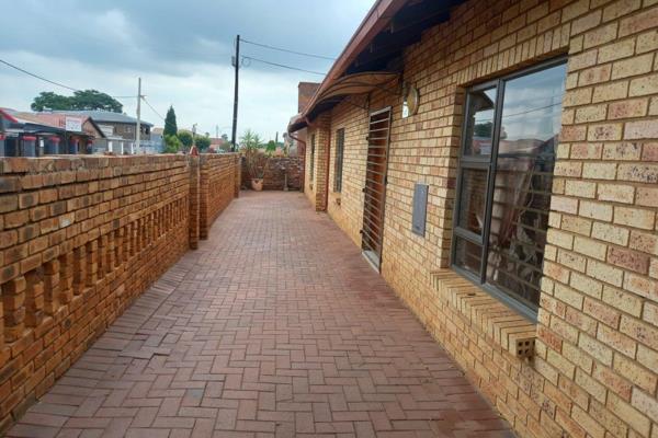 Discover this beautiful face brick corner home, perfectly situated in the heart of Lenasia. This well-maintained property offers a warm ...