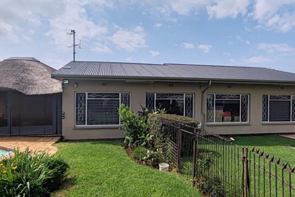 Elegant corner stand showcasing a spacious lounge, separate dining room, and large TV ...