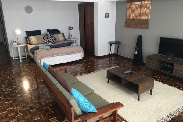 This cozy studio apartment offers a front courtyard, an open-plan bedroom/living area, a ...