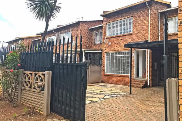 A cozy 3-bedroom duplex in Florida Roodepoort with a full bathroom, open-plan kitchen and dining, private lounge, garden, carport, and ...