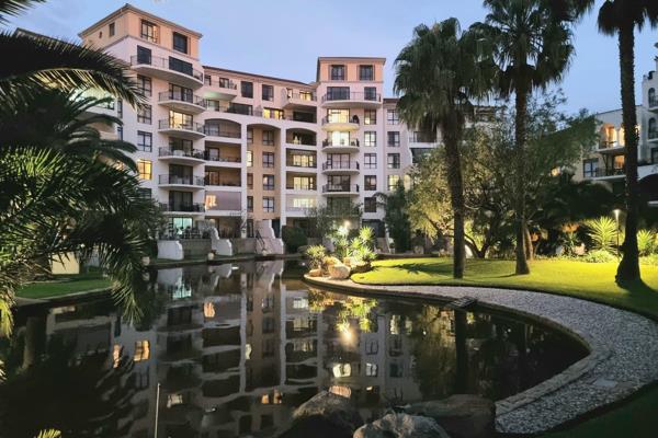 This lovely north-facing apartment offers elevated views out toward the canal and impressive evening sunsets.

The open-plan living ...