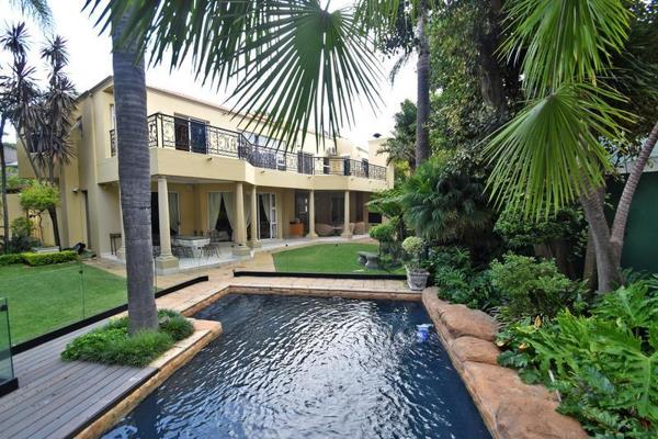 This home is accessed via a pan handle leading to a Hollywood-style portico and ample parking. The double volume skylight entrance ...