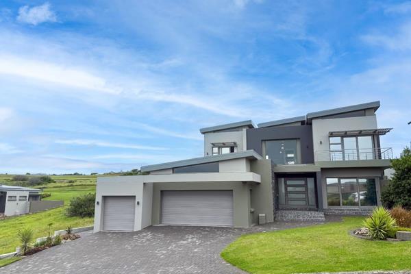 Nestled within the prestigious Oubaai Golf Estate, this modern 4-bedroom residence ...