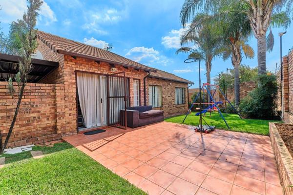 Open plan tiled lounge/dining room with sliders out to a tiled open patio and ...