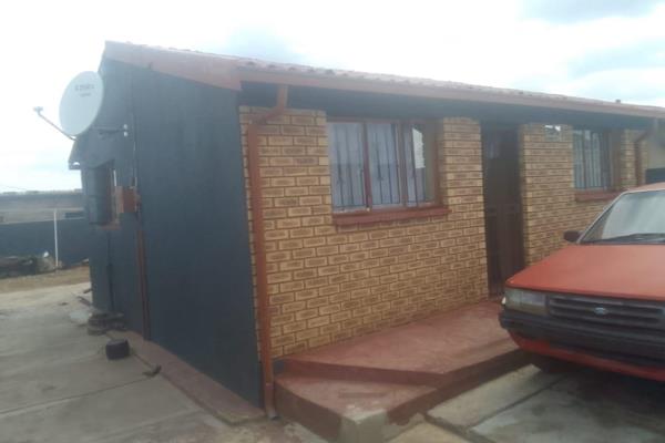 Four room house with kitchen and lounge, outside toilet, parking space for 8 cars, wall and gate 