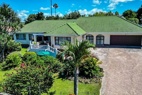 This stunning four bedroom retreat is surrounded by a lush garden filled with vibrant greenery, fruit trees, and a thriving vegetable ...