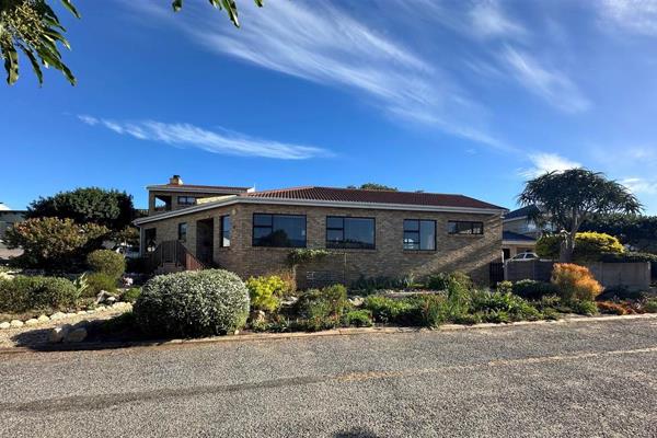 Experience the charm of coastal living in this inviting Stilbaai West home, where ...