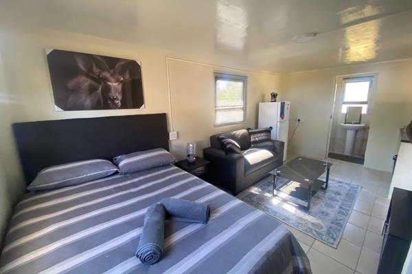 Peaceful garden Studio apartment with Spacious patio located in wind free farm setting.