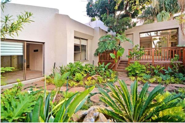 A double solid wood front door opens into an entrance hall with skylights and flows into the lovely kitchen with pop-up plugs, a wine ...