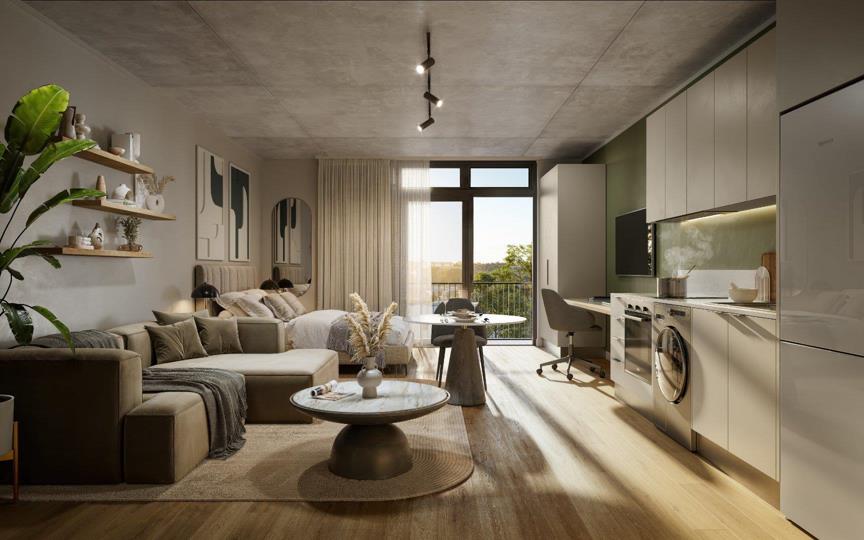 Wide-angle CGI render of a studio-style open-plan unit showing a large L-shaped sectional sofa, round marble coffee table, dining table, study desk with chair, bed with neutral linen against the far wall, full-height whi
