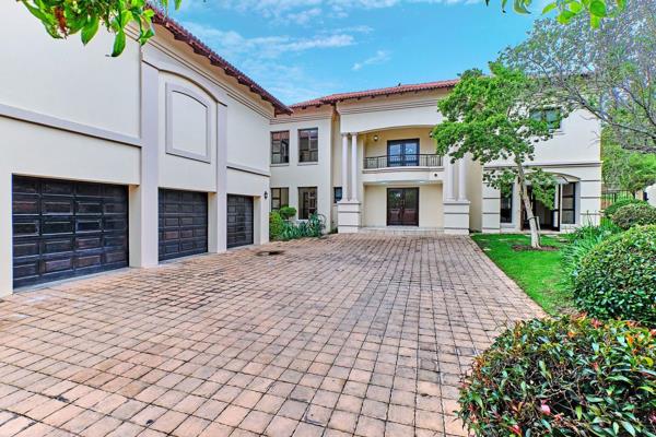 A grand staircase welcomes you as you step through the front door, leading to a spacious entertainer&#39;s patio complete with a ...