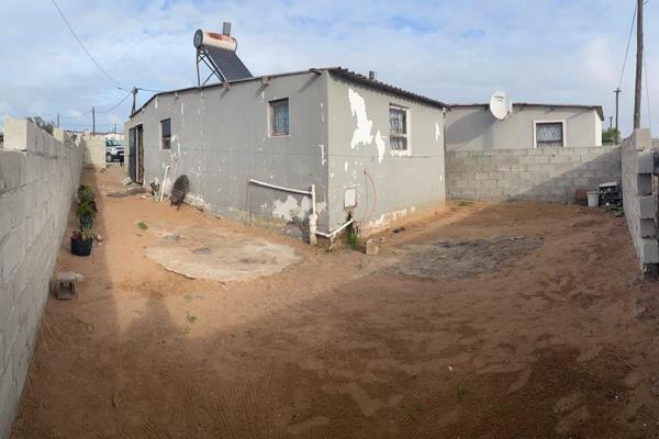 This is a two-bedroom house with a kitchen/lounge and large bathroom.

 There is enough space to build on. In front is a garage in the ...