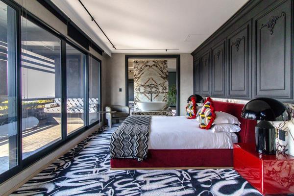 This Exquisite &quot;Black Coffee&quot; Inspired Penthouse at Hallmark House is a striking double-story suite crafted through the visionary collaboration of acclaimed artist Black Coffee, interior designer Tristan du Plessis, and ...