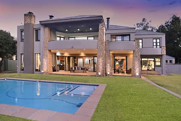 From the impressive double volume entrance hall with dual sweeping staircases the home ...