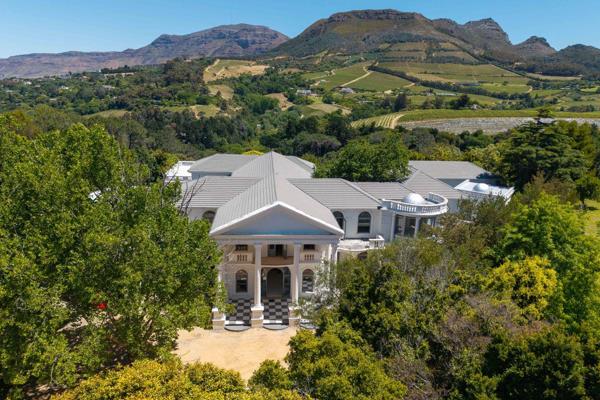 SOLE AND EXCLUSIVE MANDATE

Palatial living awaits in this grand Constantia residence, set in complete privacy with breathtaking views ...
