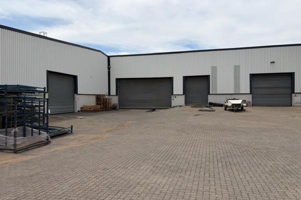 This large free standing warehouse featuring roller doors at the front, back and side ...