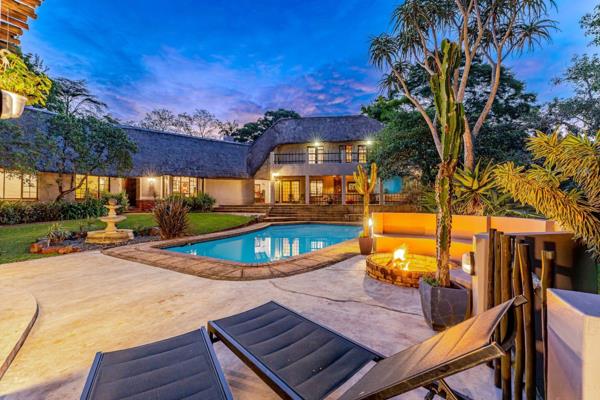 This move-in-ready double-storey thatch home offers country-style charm with modern luxury on a subdivisible level acre in sought-after Hillcrest Park.

Step into a welcoming mud ...