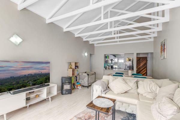 This is a 2-bedroom, 2-bathroom apartment featuring an open-plan kitchen with a combined ...