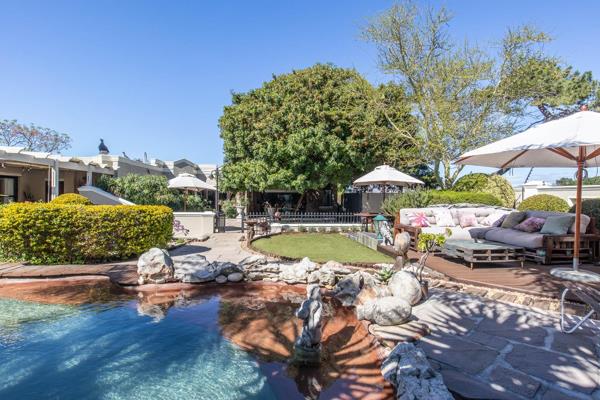 Tucked away in beautiful established gardens framed by by the Constantiaberg Mountains ...