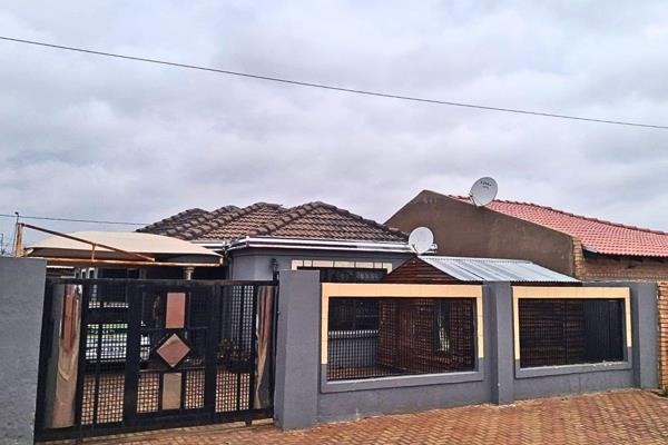 A neat, secure family home in the well-established Dobsonville Gardens neighbourhood, offering comfortable living space behind solid ...