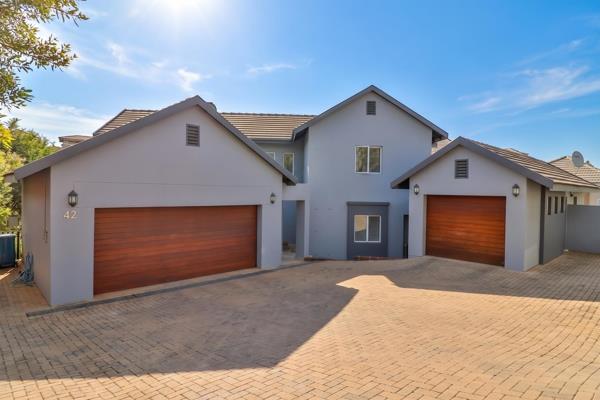 This spacious family home is set on a greenbelt stand and offers four en-suite bedrooms ...