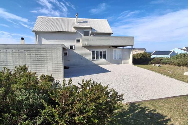 This charming Key West-inspired coastal beach house combines relaxed seaside living with ...