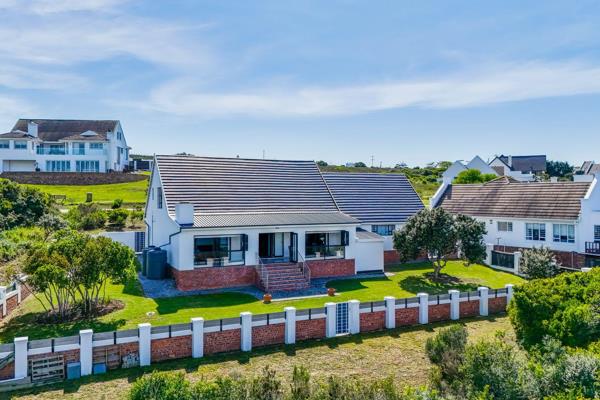 Experience the pinnacle of Kromme River Estate living with this immaculate, front-row ...